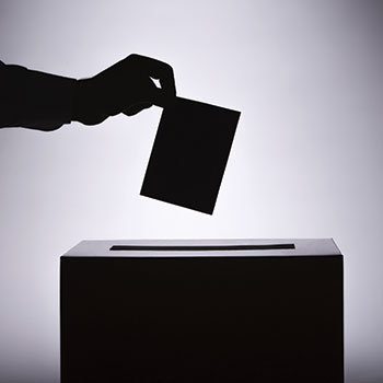 Spotlight story image pertaining to silhouette of hand placing ballot in box
