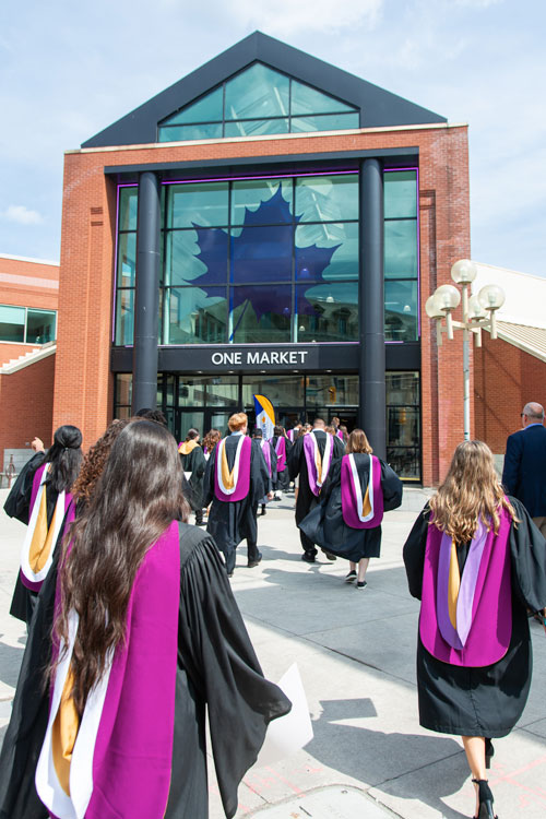 Students walking toward One Market building