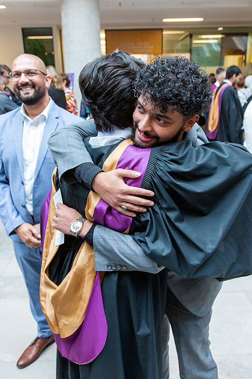 grad hugging family member
