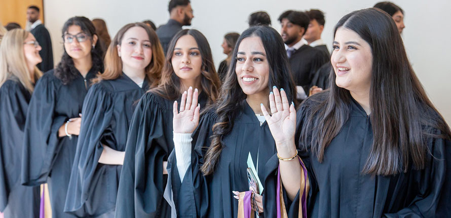 Science graduates waving before ceremony