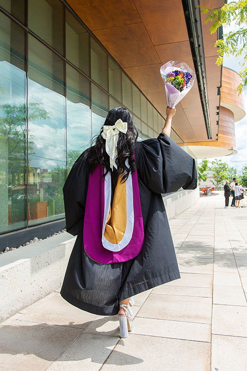grad outside with flowers