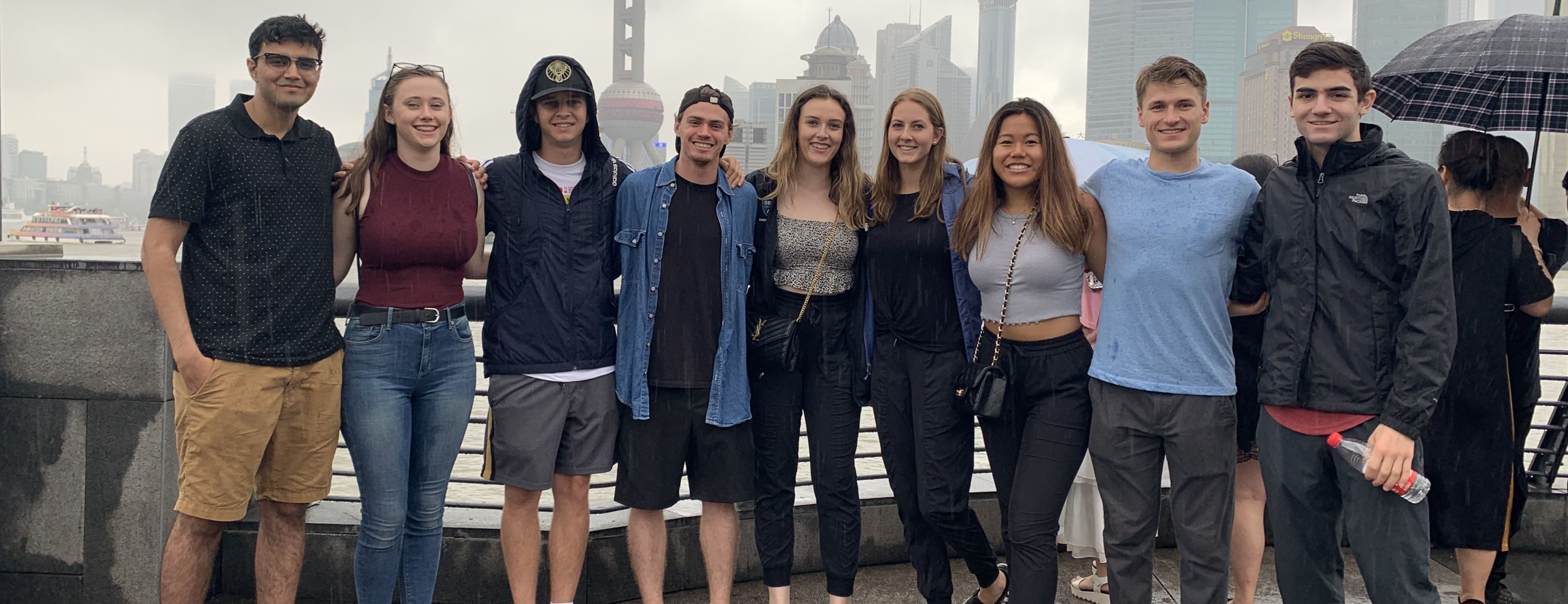 group of students standing in front of the skyline