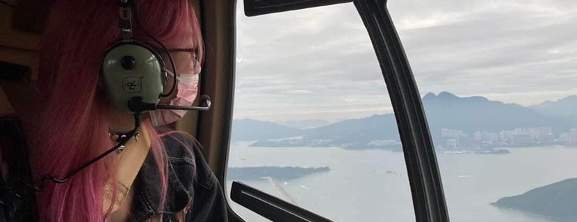 Amy Zhou looking out of helicopter window.