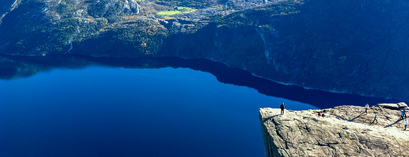 A cliff above a blue lake