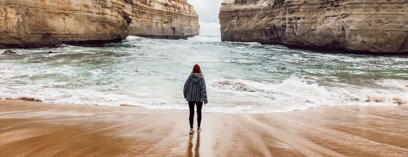 student in Australia standing on the beach looking at the ocean