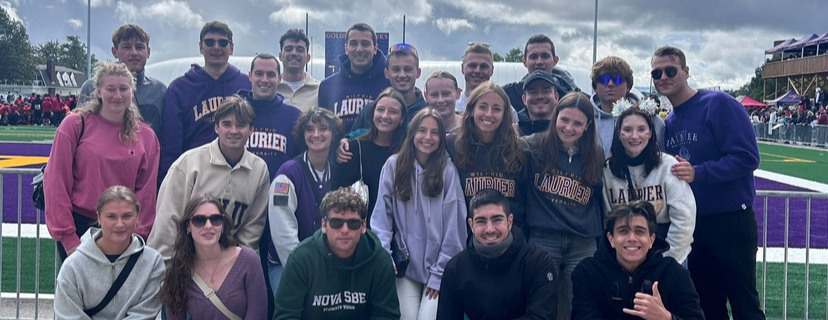 Incoming exchange students posing at University stadium.