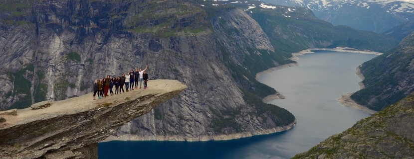 Laurier exchange students on a rock overlooking a fjord in Norway.