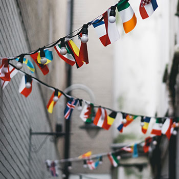 Flags of different countries hang along a rope
