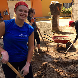 Students digging on house site