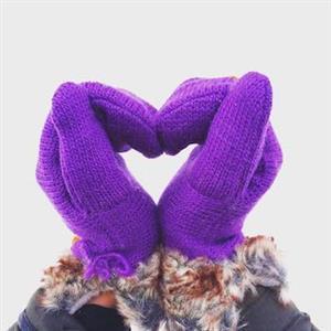 two purple gloved hands folded to make a heart