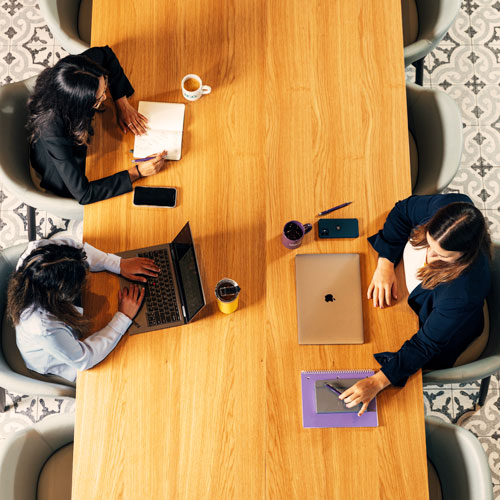 Three people having a meeting at a table