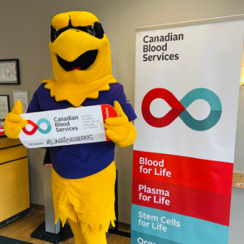 Laurier mascot holding Canadian blood donor sign 