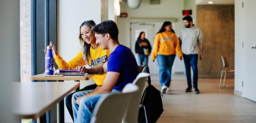 Students inside Brantford building studying and walking