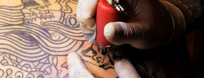 tattoo artist drawing tattoo