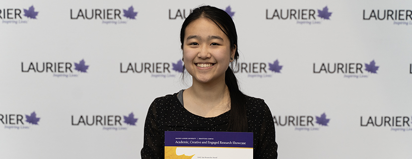 Emily Chau holding a certificate