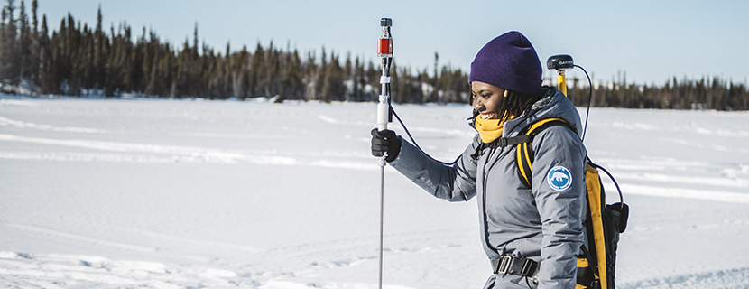 Gifty Attiah conducting field research on a snow-covered frozen lake