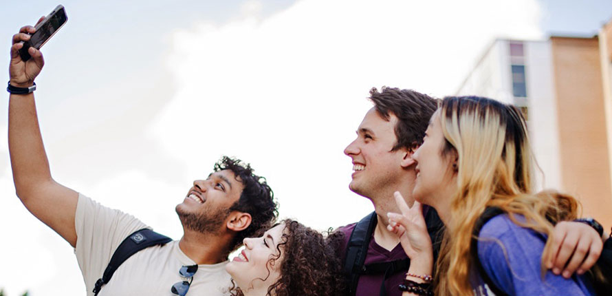 Four students taking selfie