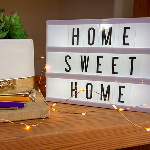Home Sweet Home light-up sign on desk