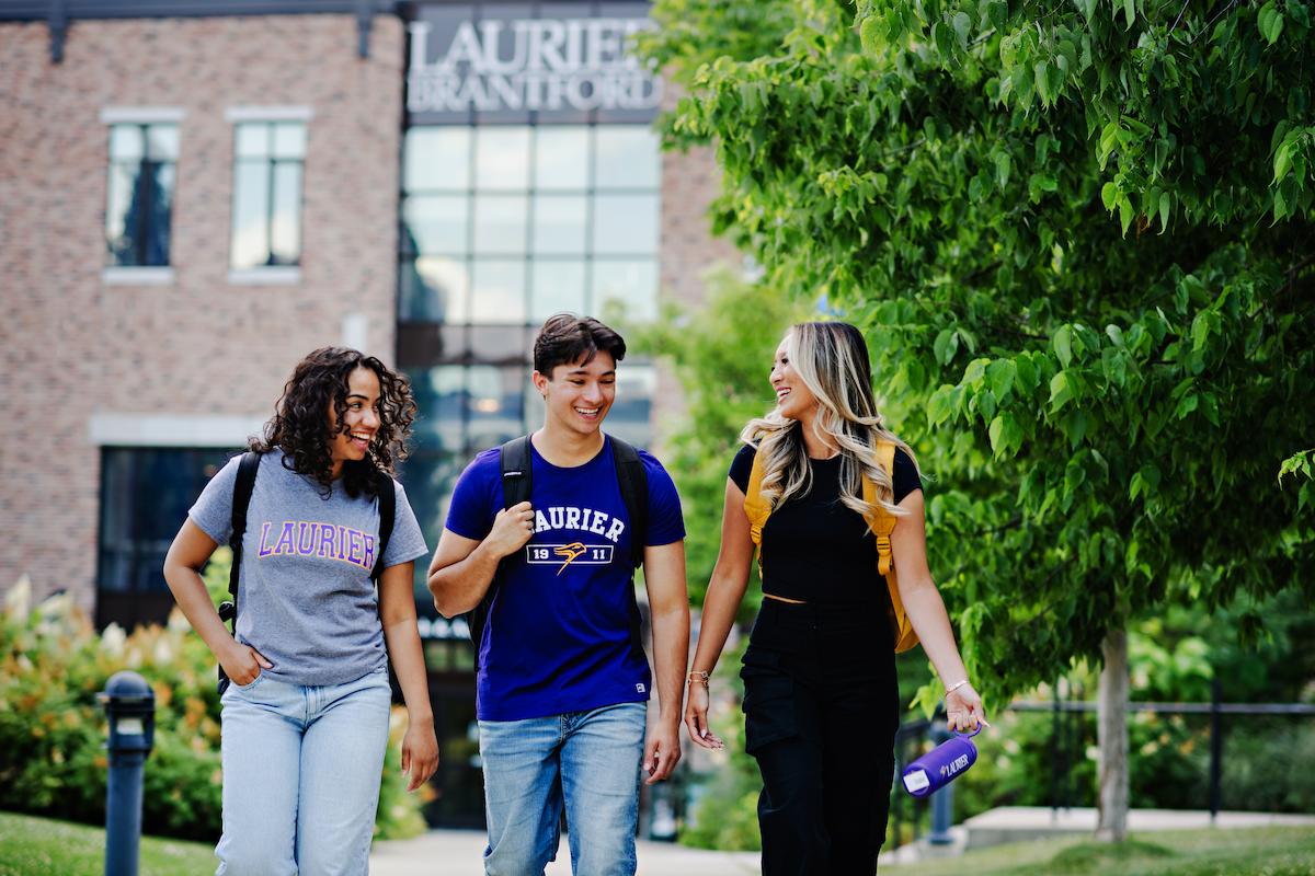 Students in Brantford walking in front of the Laurier Brantford Research and Academic Centre building.