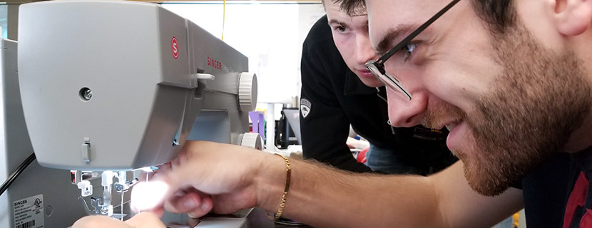 male using sewing machine