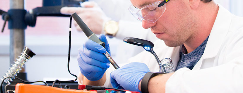 Student soldering electronic circuit