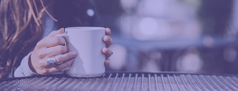 hands holding cup of coffee