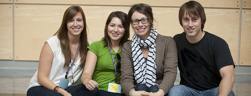 Grad students smiling at conference