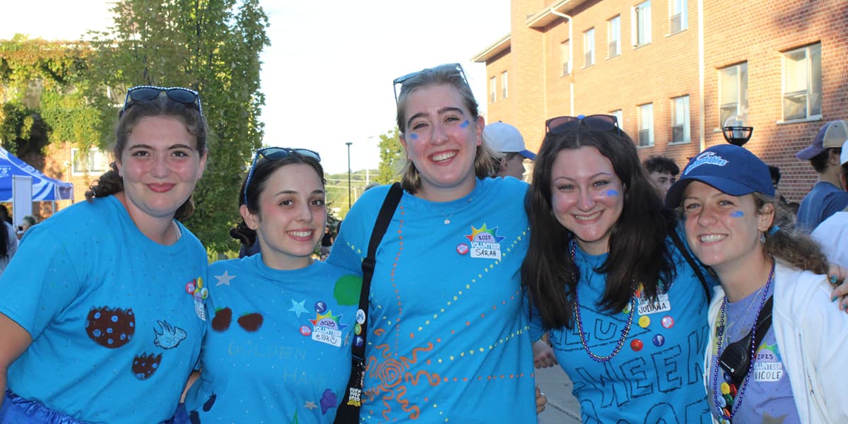 Five students wearing blue orientation shirts