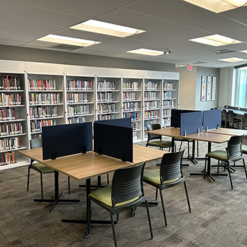 Desks in front of a library bookcase