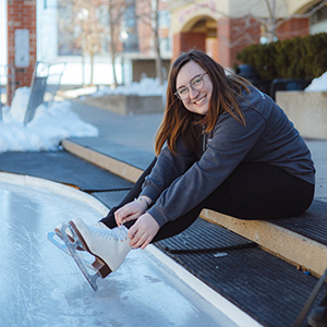 Lacing ice skates at Harmony Square outdoor ice rink