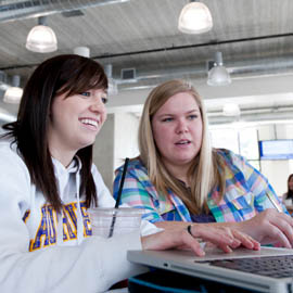Two students at laptop