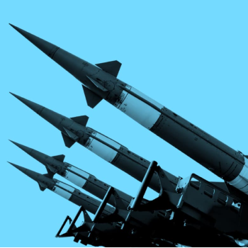 four missiles pointed towards the sky on a blue background