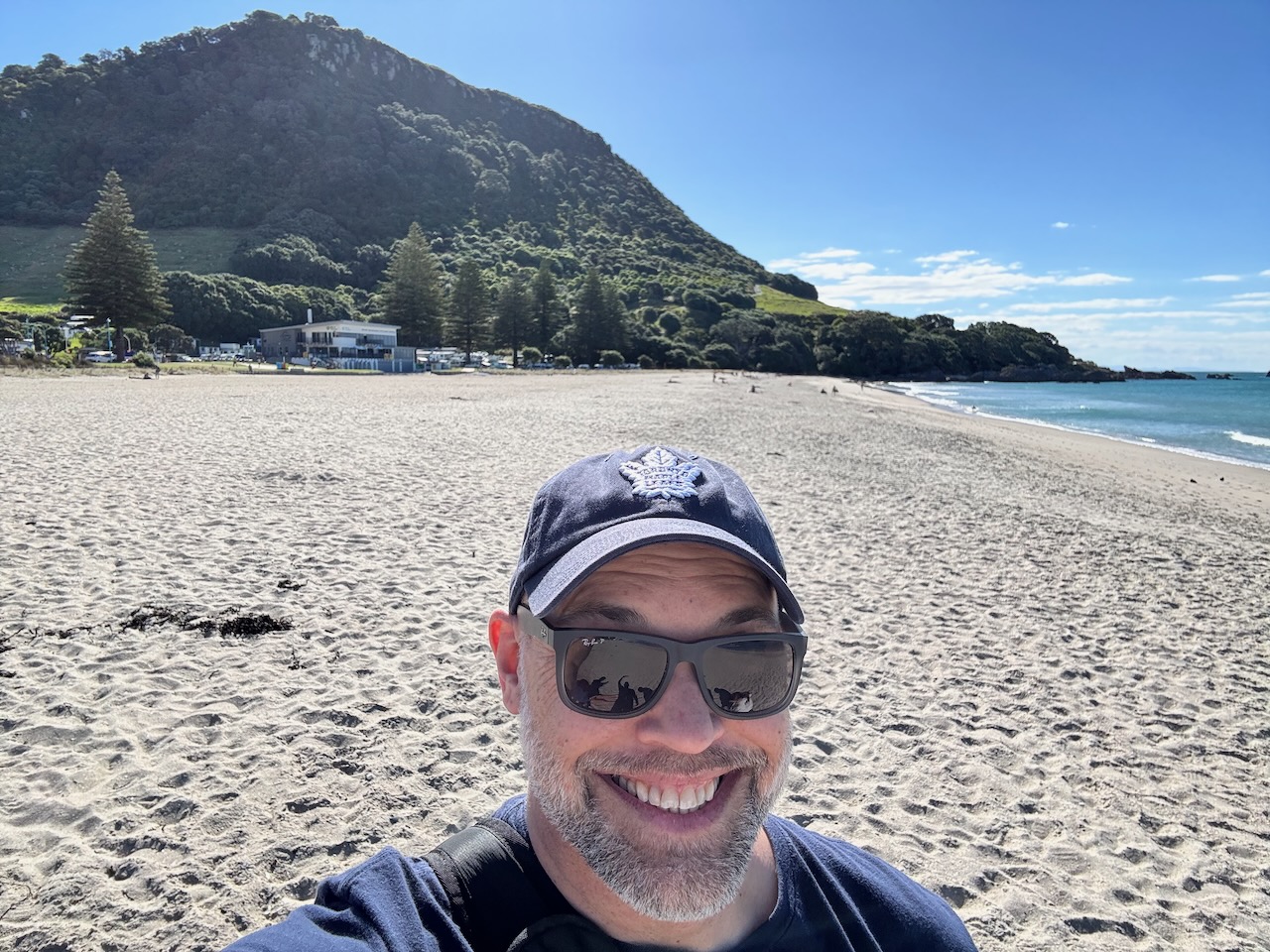 Logan – Dr. McLeod on the beach with Mount Maunganui in the background