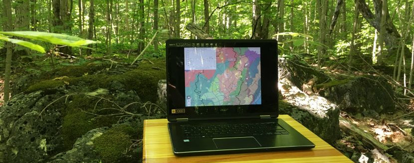 Laptop in the woods running GIS