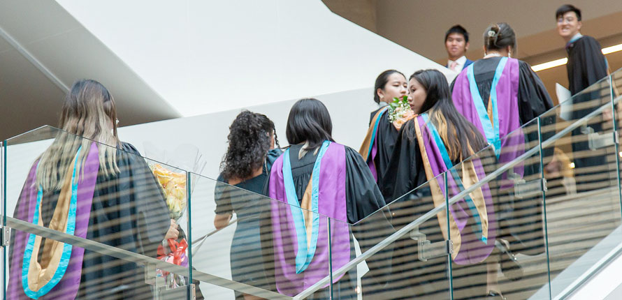 Business graduates on stairs