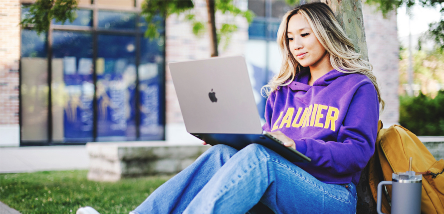 Student typing on laptop