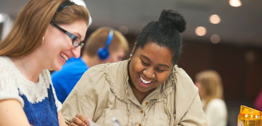 Two students laughing