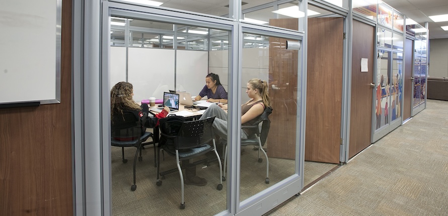 Students in a booked study room in the 24 Lounge on the Waterloo campus