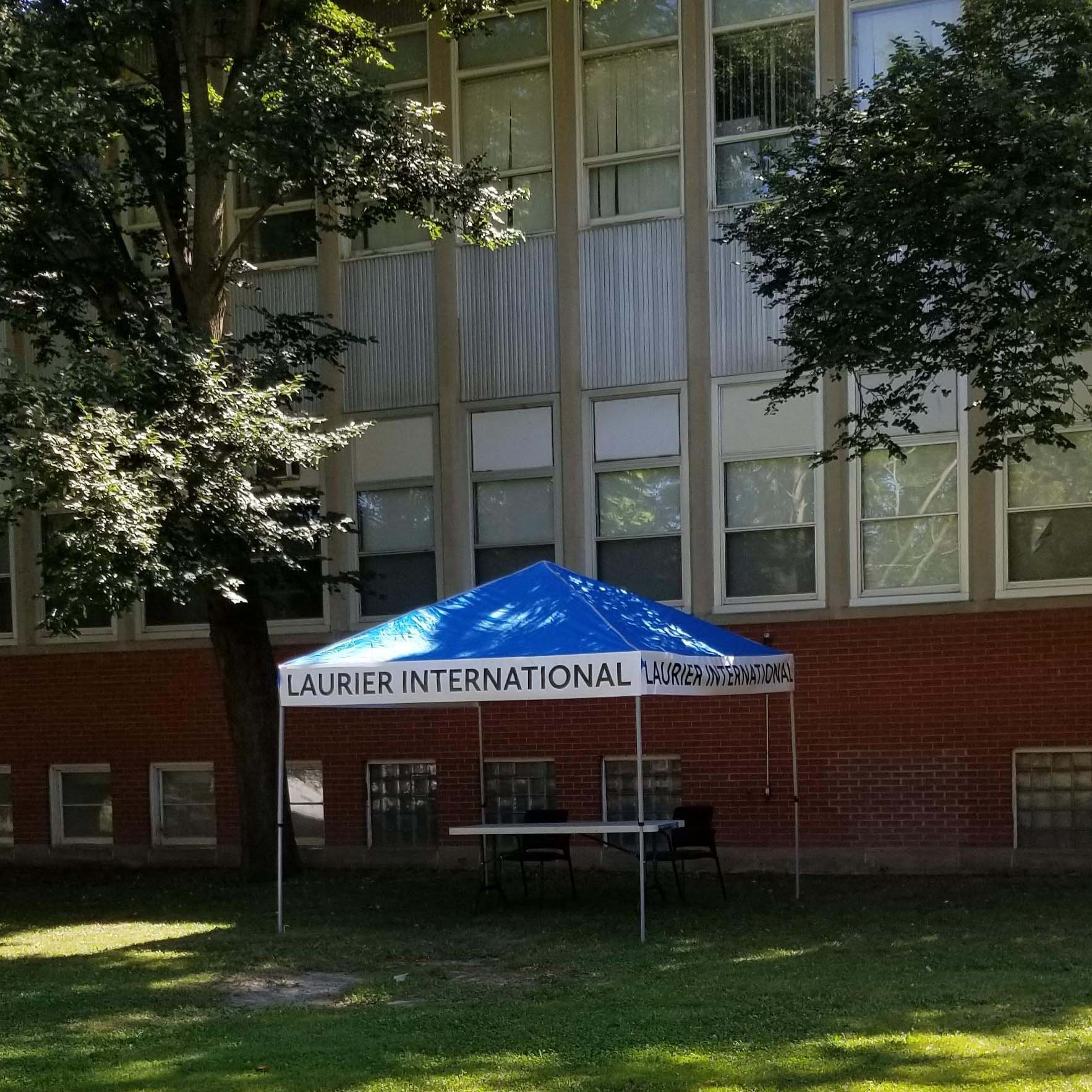 Blue canopy with a banner saying Laurier International
