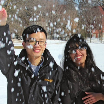 students throwing snowballs