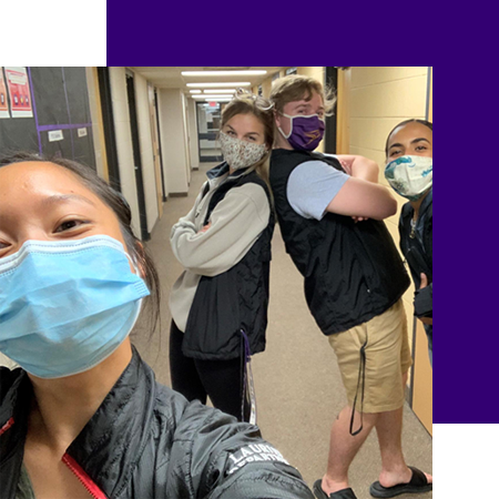 students in hallway wearing masks