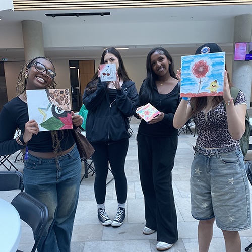LOCUS students holding up their artwork