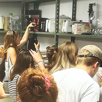 Students looking at shelves of kitchenware